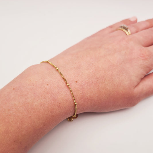 18K gold plated beaded bracelet on wrist, adjustable, tarnish-free, waterproof steel by Forge and Lumber.