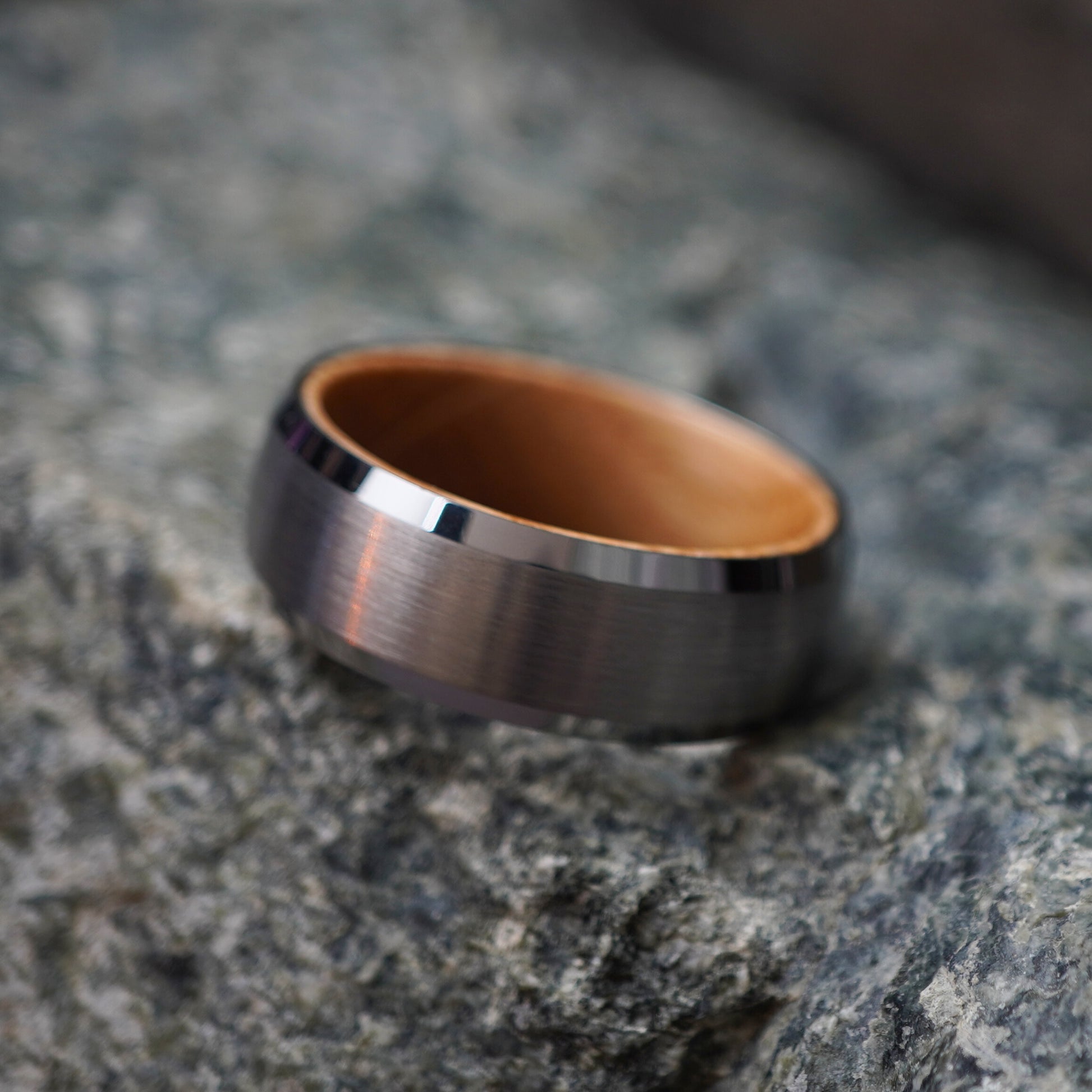 Forge and Lumber Glencairn 8mm men's ring with a brushed metal exterior and natural barrel wood interior.