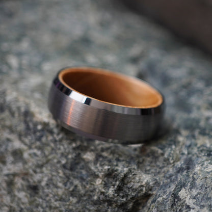 Forge and Lumber Glencairn 8mm men's ring with a brushed metal exterior and natural barrel wood interior.