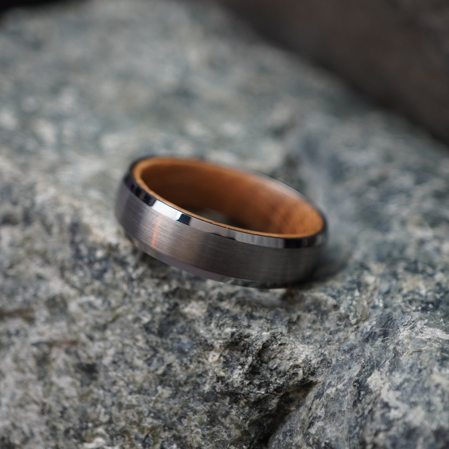 Matte black bevelled ring with barrel-wood interior, 6mm width, by Forge and Lumber.
