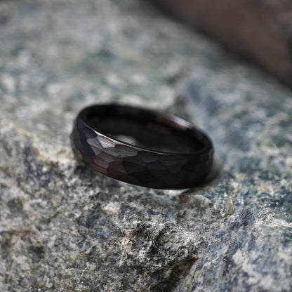 Black tungsten wedding band featuring a faceted design by Forge and Lumber. Available in sizes UK K to M.