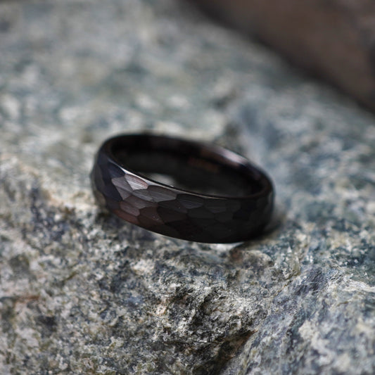 Black tungsten wedding band featuring a faceted design by Forge and Lumber. Available in sizes UK K to M.