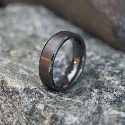Beveled black zirconium ring, 6mm wide, by Forge and Lumber, available in UK K to M sizes.