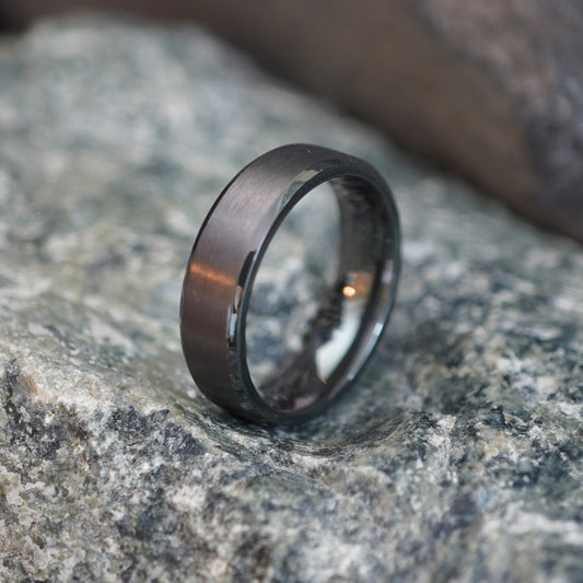 Beveled black zirconium ring, 6mm wide, by Forge and Lumber, available in UK K to M sizes.