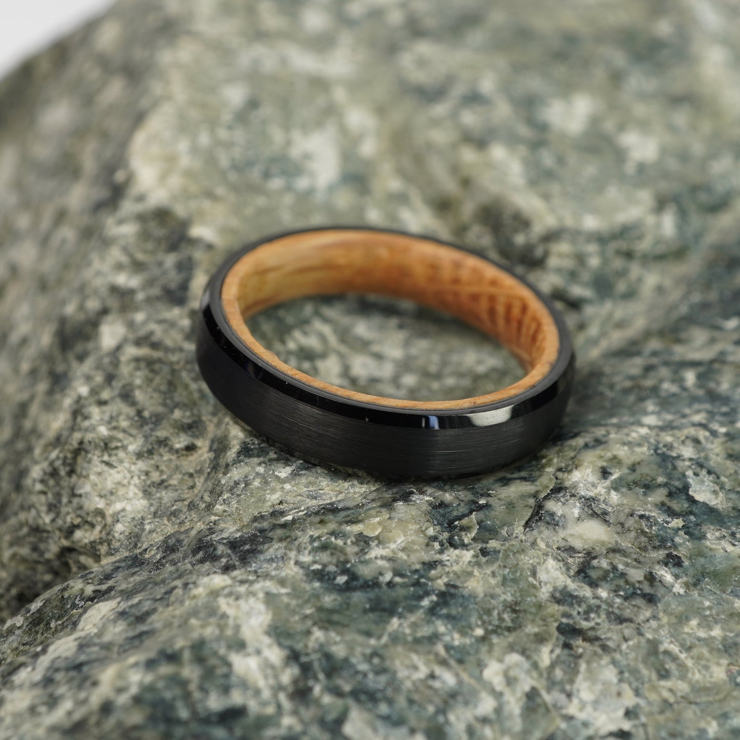 Black beveled ring with barrel wood inner lining, 4mm width, by Forge and Lumber.