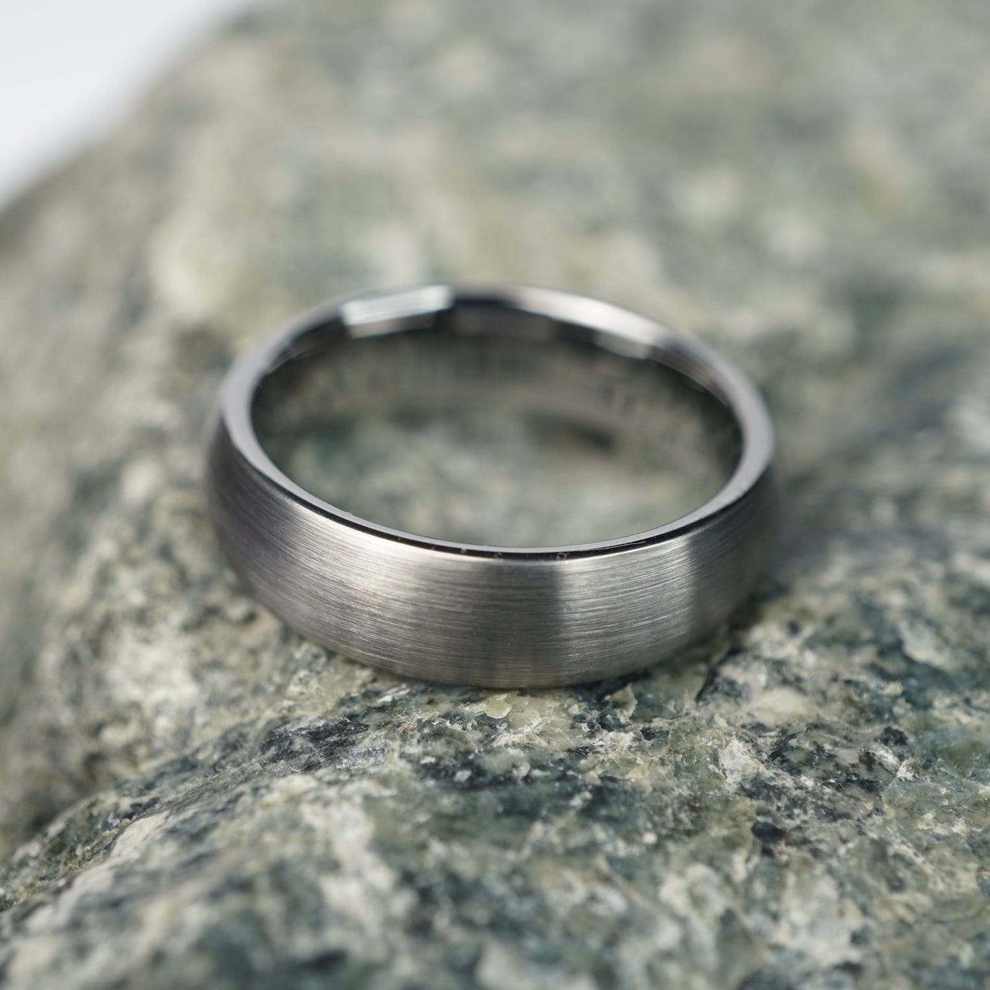 Brushed silver tungsten ring with a sleek, modern design.
