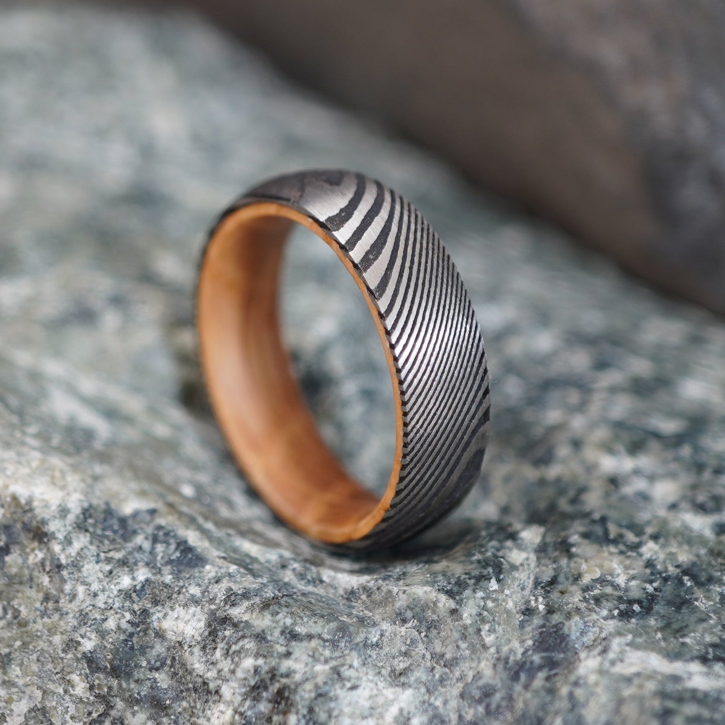Damascus wedding band with unique wood interior, 6mm width, by Forge and Lumber.