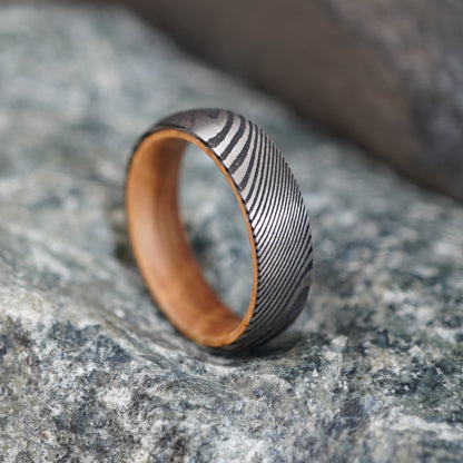 Damascus wedding band with unique wood interior, 6mm width, by Forge and Lumber.