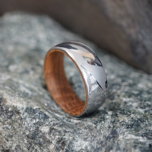 Damascus steel ring with a polished finish, featuring a wooden interior, by Forge and Lumber. Size UK M / US 6.