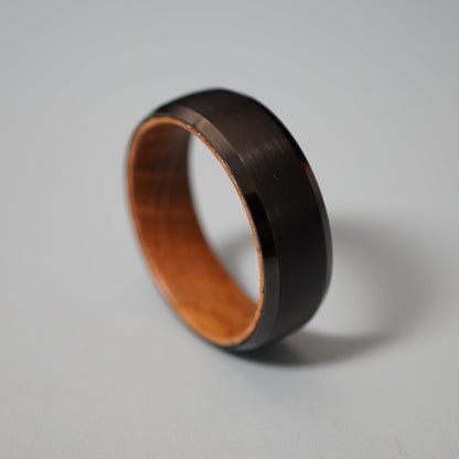 Black wooden ring with a polished exterior and natural wood interior.