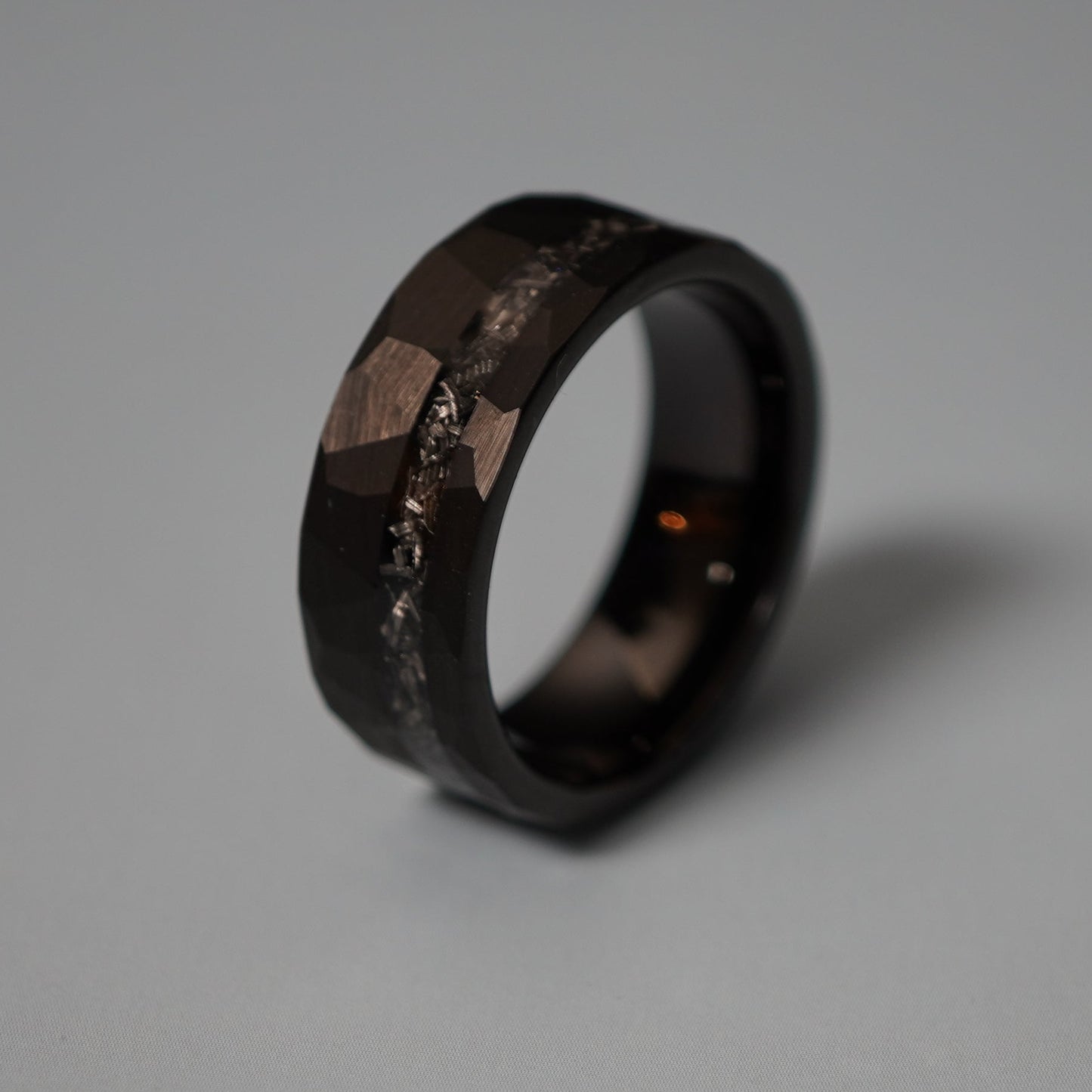 Black durable ring with a faceted design and textured band by Forge and Lumber, available in sizes UK M, N, O.