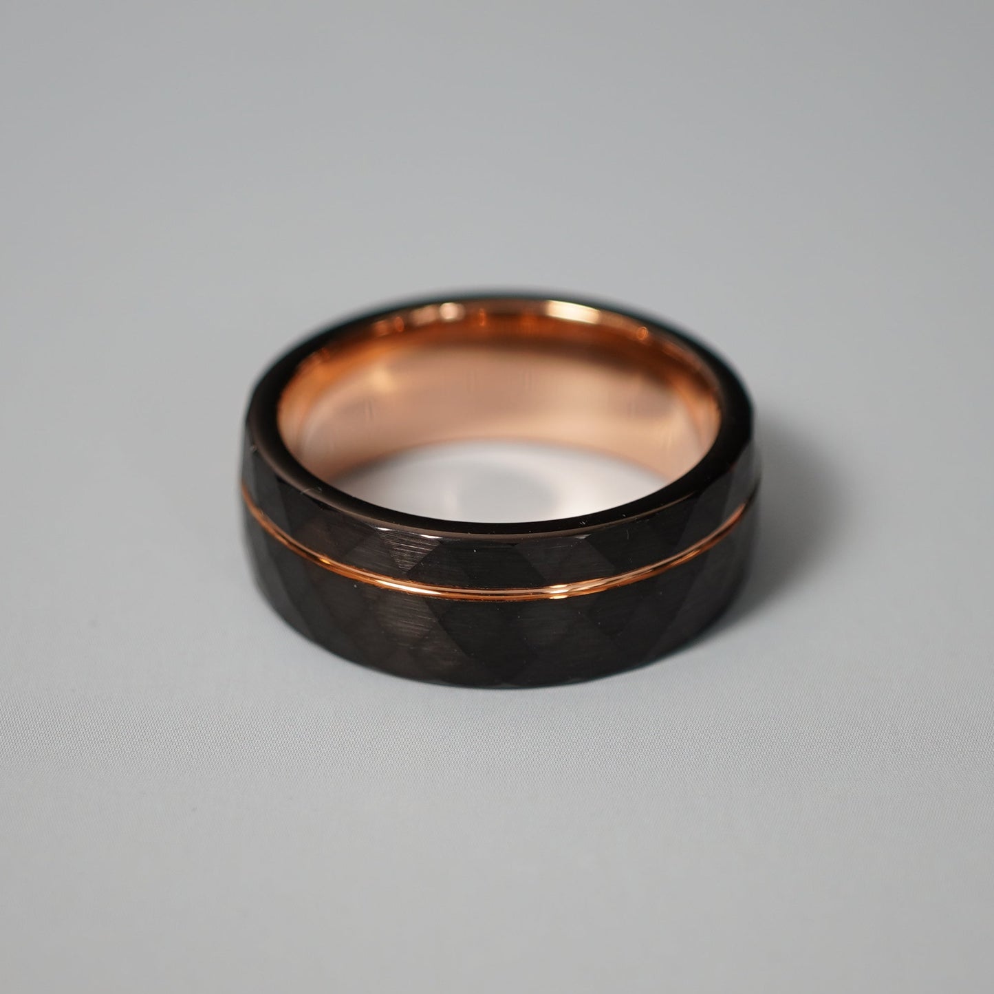 Black active lifestyle ring with 8mm width and rose gold accents by Forge and Lumber.