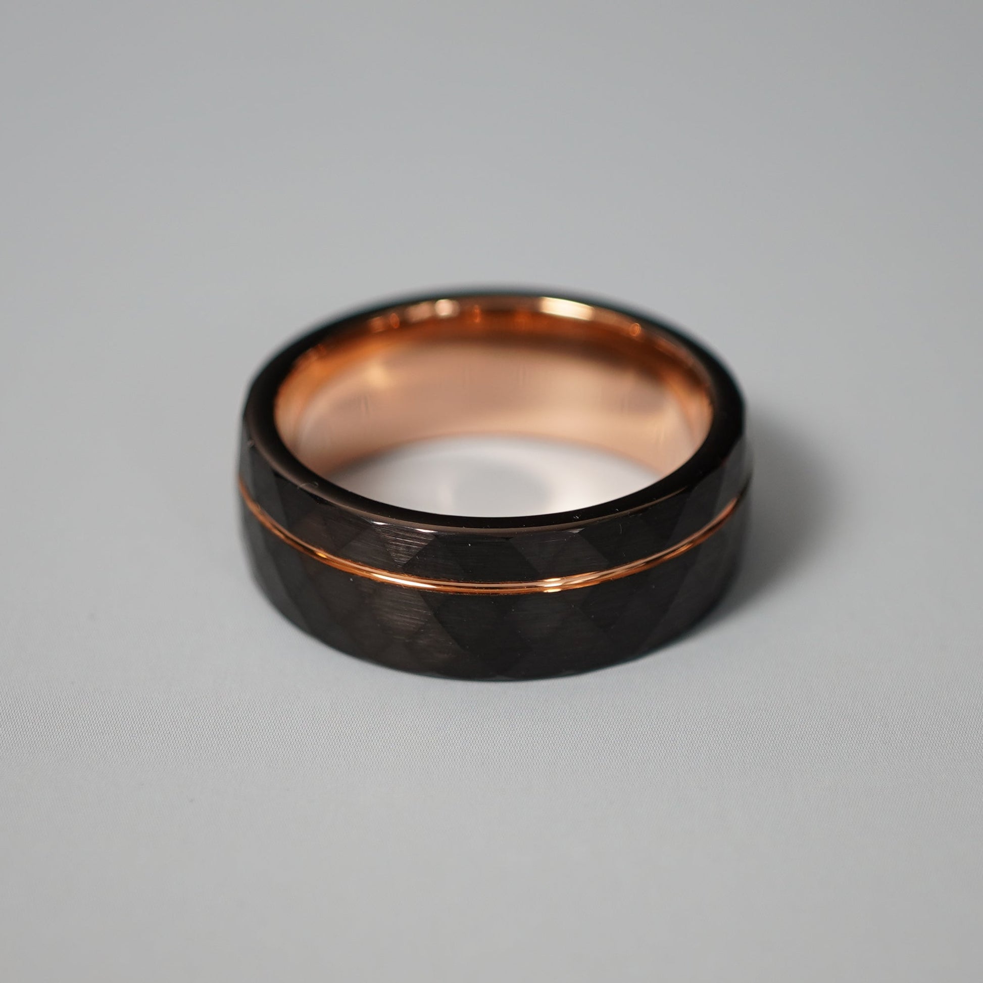 Black active lifestyle ring with 8mm width and rose gold accents by Forge and Lumber.
