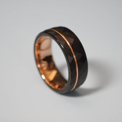 Black active lifestyle ring with a faceted surface and rose gold inlay by Forge and Lumber, 8mm wide.
