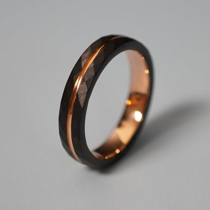 Black and rose gold engravable ring by Forge and Lumber with a delicate, faceted design.