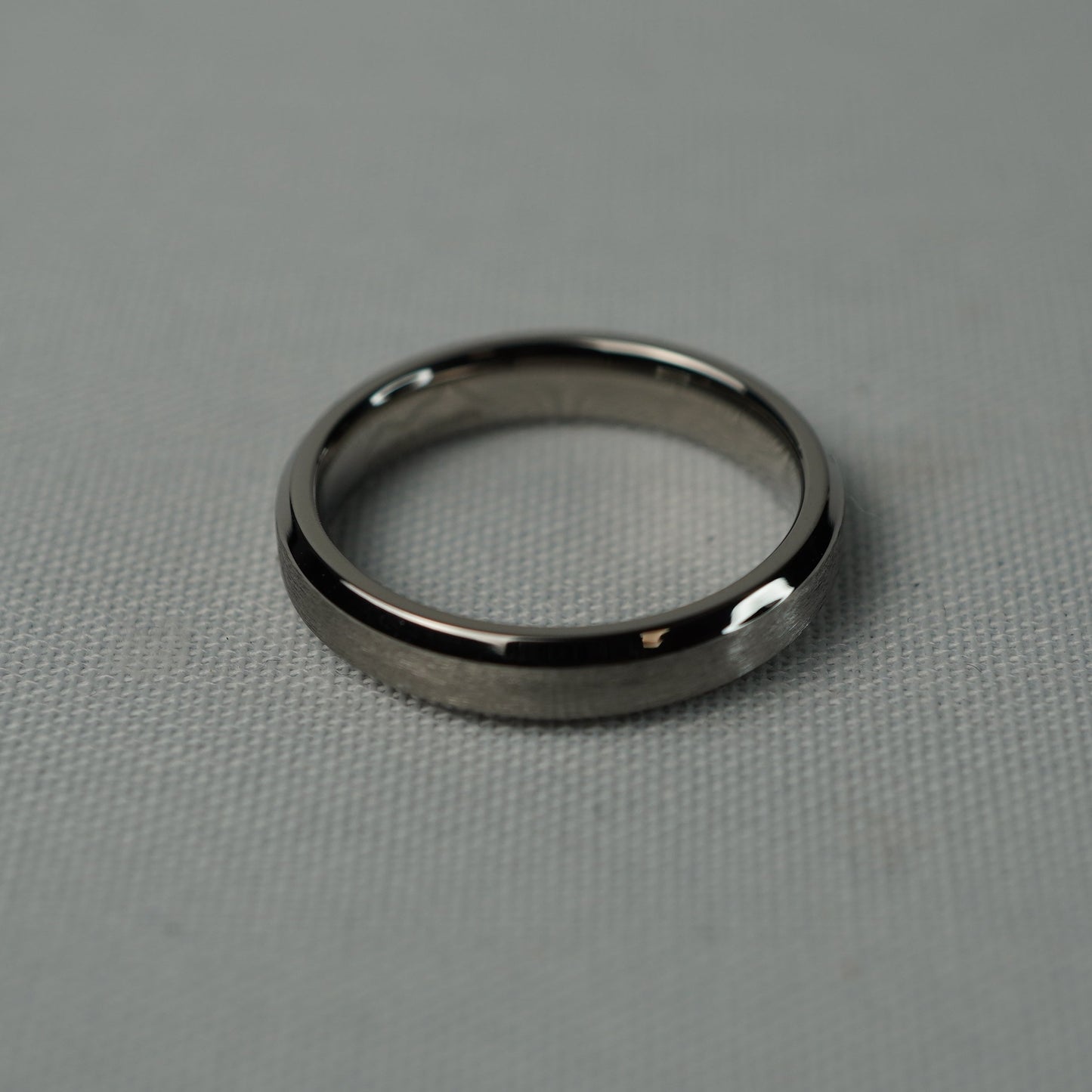 Silver ring on a gray textured surface
