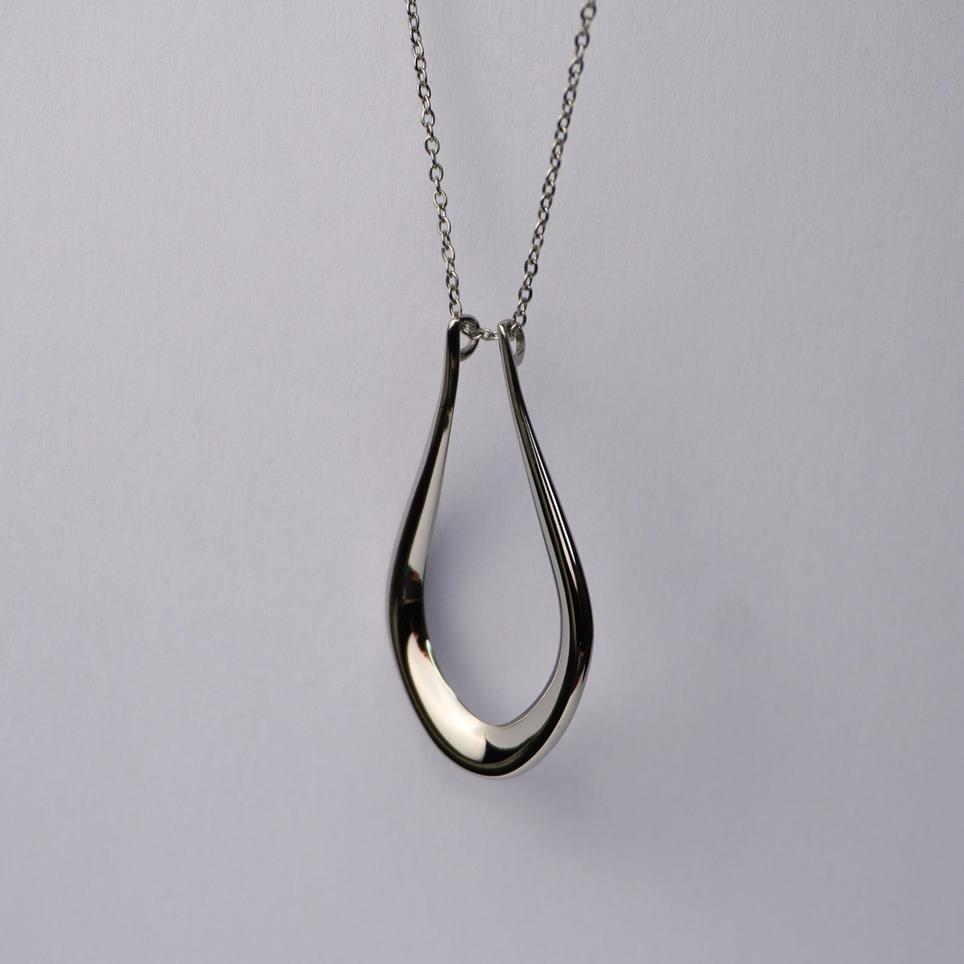 Silver teardrop pendant necklace on a delicate chain.