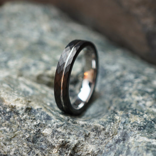 Silver 4mm band ring with a delicate design, engravable, by Forge and Lumber on textured rock background.