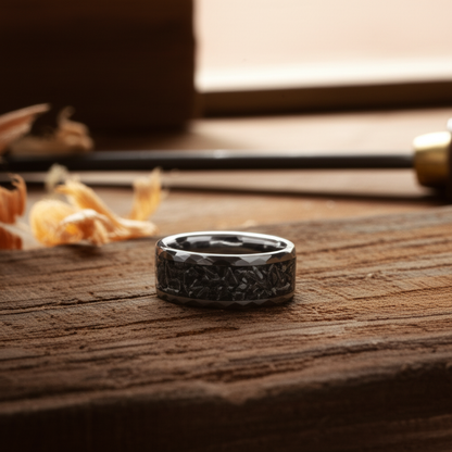 Black 8mm alternative metal wedding band with celestial design by Forge and Lumber, displayed on a wooden surface.