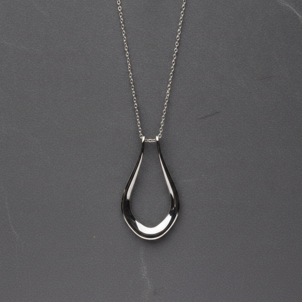 The Abalone necklace worn with a ring on the chain