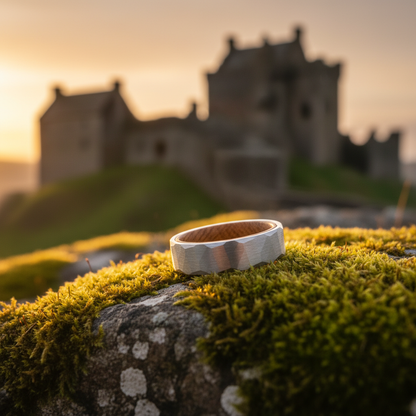 Forge & Lumber Cask ring. Barrel-inspired 6mm band on mossy stone ruins. Heritage anniversary jewelry.