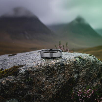 Beveled 8mm active lifestyle ring in stainless steel by Forge and Lumber, set against a misty mountain backdrop.