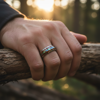 Abalone inlay black ring, 8mm width, by Forge and Lumber, worn on hand outdoors.
