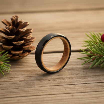 Beveled black barrel-wood ring by Forge and Lumber, 4mm width, with natural wood interior